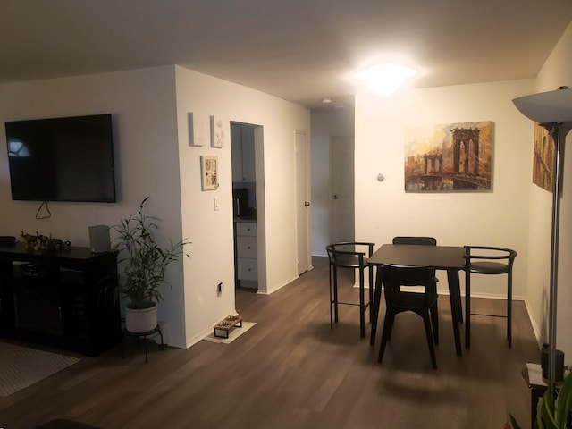 dining room with dark wood-type flooring