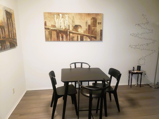 dining space with hardwood / wood-style flooring