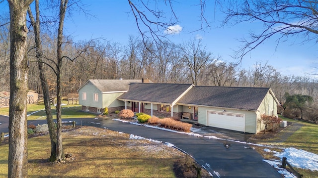 view of front of house featuring a garage and a front lawn