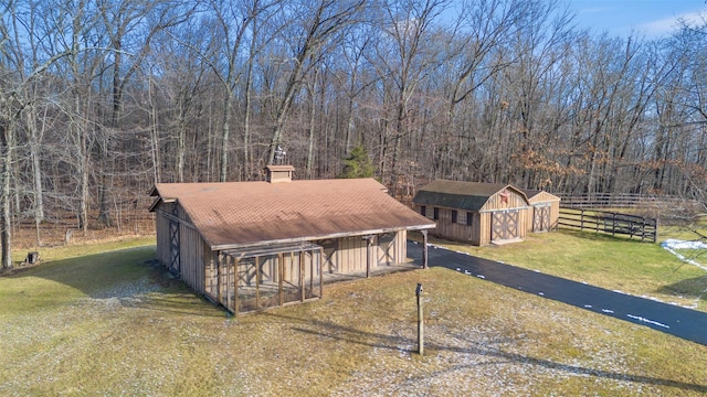 exterior space featuring a front lawn and an outdoor structure