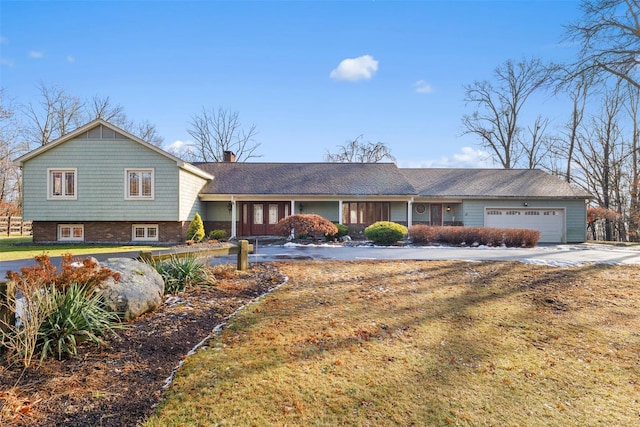 split level home with a garage and a front lawn