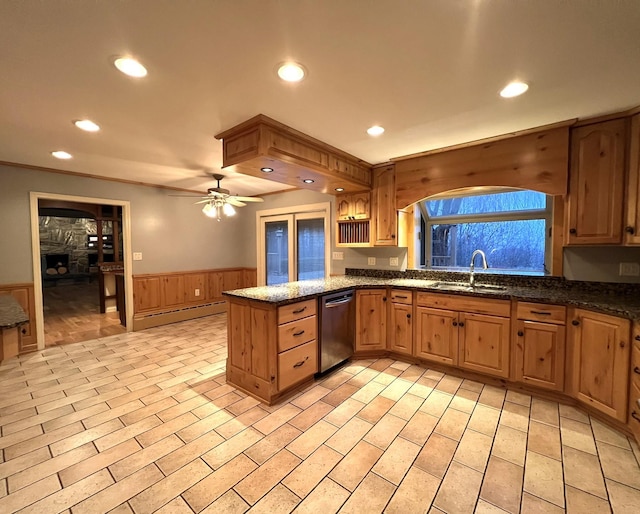 kitchen with ceiling fan, dishwasher, sink, baseboard heating, and kitchen peninsula