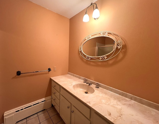 bathroom featuring tile patterned flooring, vanity, and baseboard heating