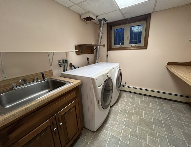 laundry room with baseboard heating, sink, cabinets, and independent washer and dryer