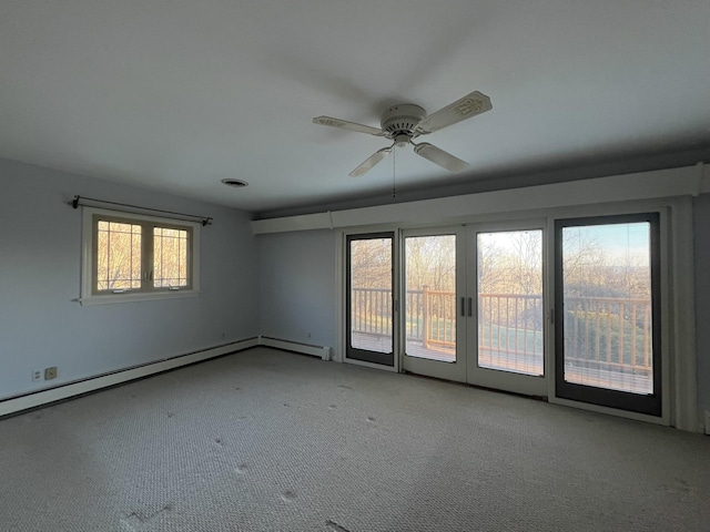 unfurnished room featuring ceiling fan, light carpet, and a baseboard heating unit