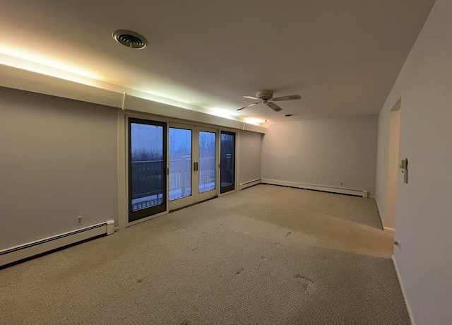 carpeted empty room featuring baseboard heating and ceiling fan