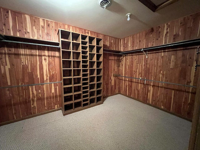 walk in closet featuring light carpet