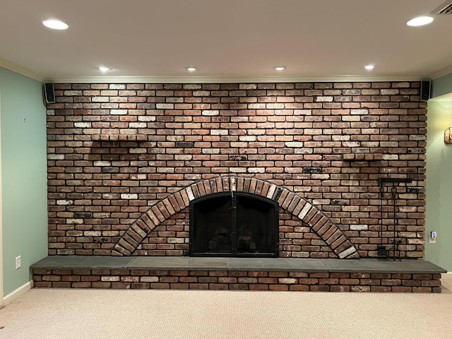 interior details with a brick fireplace, carpet floors, and ornamental molding