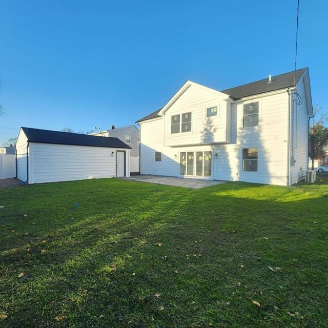 back of property featuring a patio, cooling unit, an outdoor structure, and a lawn