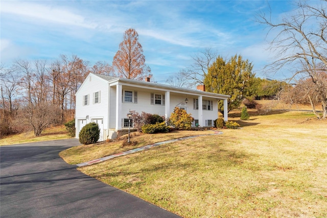 view of front of house featuring a garage and a front yard