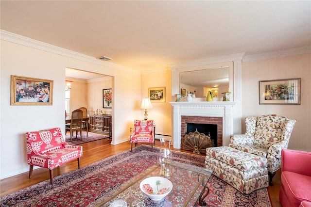 living room featuring a brick fireplace, hardwood / wood-style floors, and ornamental molding