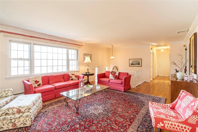 living room with crown molding and light hardwood / wood-style floors