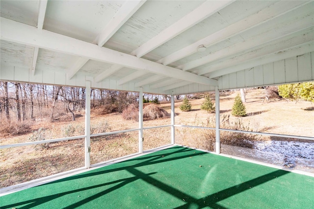 unfurnished sunroom featuring lofted ceiling