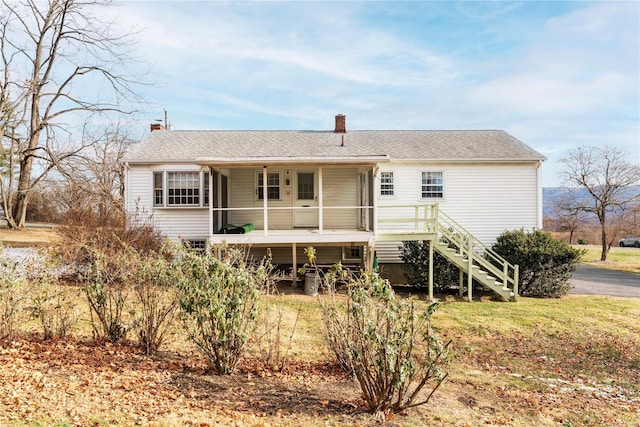 rear view of house featuring a sunroom