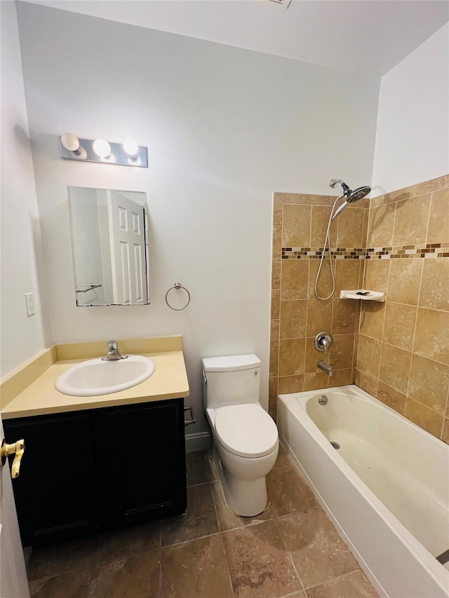 full bathroom with tiled shower / bath combo, vanity, and toilet