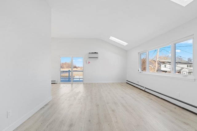 unfurnished room featuring light hardwood / wood-style flooring, lofted ceiling with skylight, and a baseboard heating unit