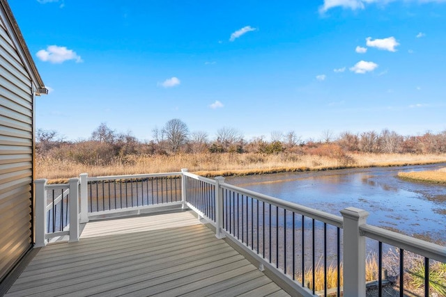 wooden terrace featuring a water view