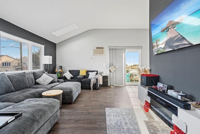 living room featuring hardwood / wood-style floors, lofted ceiling, and a wall mounted AC