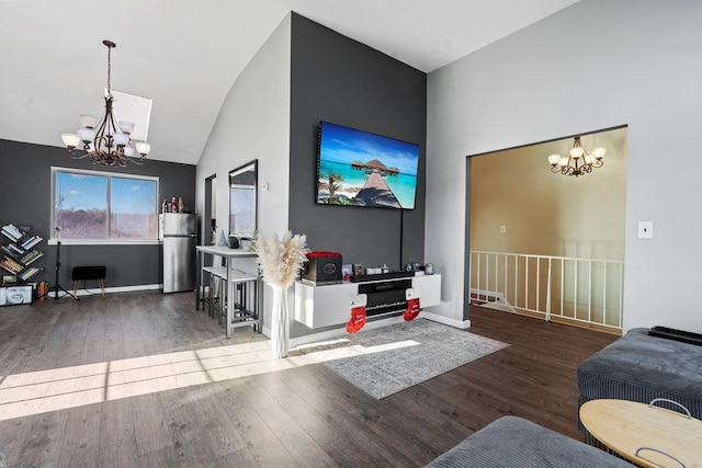 living room with dark hardwood / wood-style flooring, high vaulted ceiling, and a notable chandelier