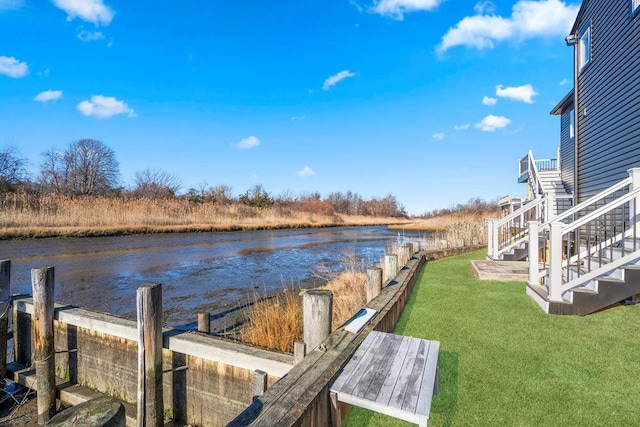 dock area featuring a lawn and a water view