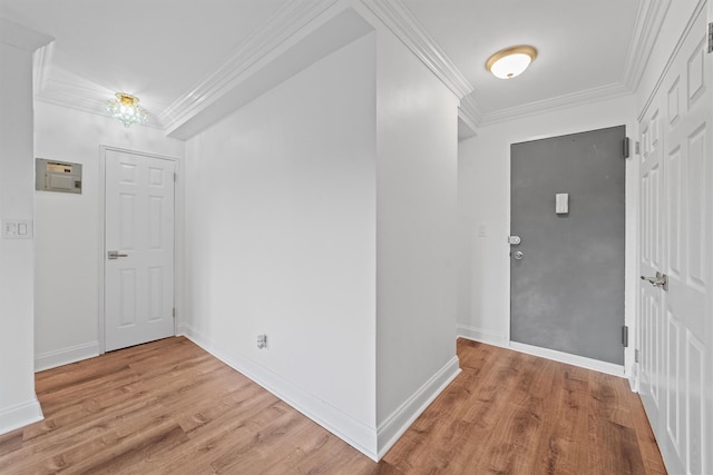 entrance foyer featuring light hardwood / wood-style flooring and ornamental molding