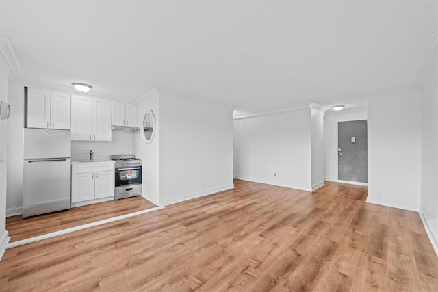 unfurnished living room featuring sink, ornamental molding, and light wood-type flooring