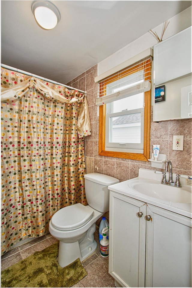 bathroom featuring toilet, tile walls, tasteful backsplash, and vanity