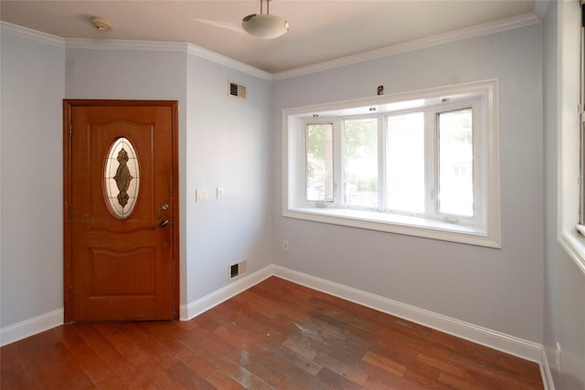 foyer entrance with dark hardwood / wood-style flooring and ornamental molding