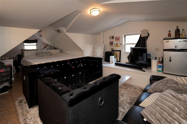 recreation room featuring wood-type flooring, lofted ceiling, and a wealth of natural light