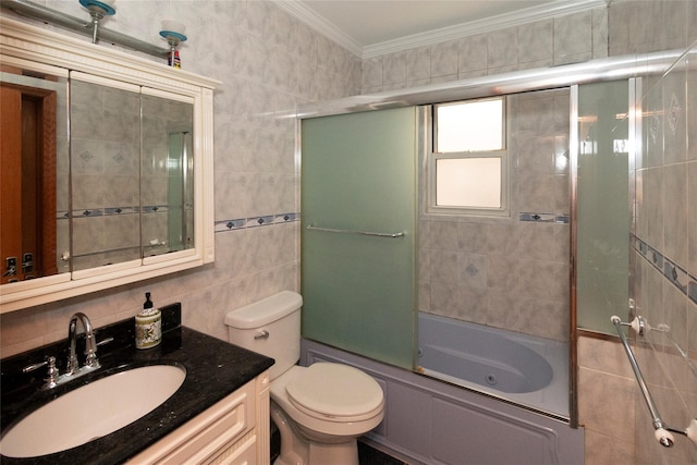 full bathroom featuring vanity, crown molding, tile walls, enclosed tub / shower combo, and toilet