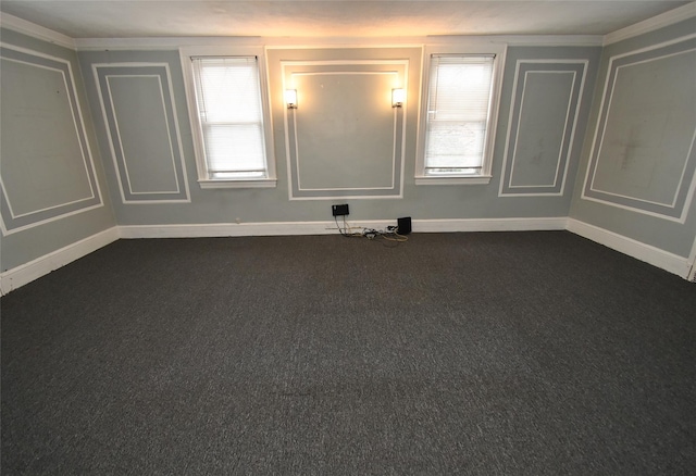 unfurnished room with plenty of natural light and dark carpet