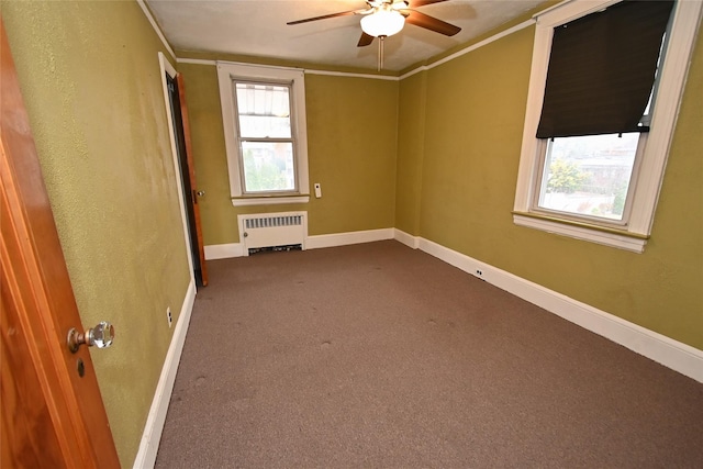 unfurnished room featuring carpet flooring, ceiling fan, crown molding, and radiator