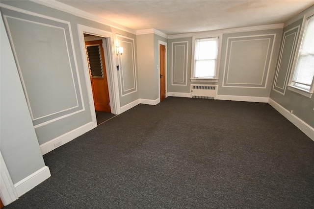 unfurnished room with radiator heating unit, dark carpet, and crown molding