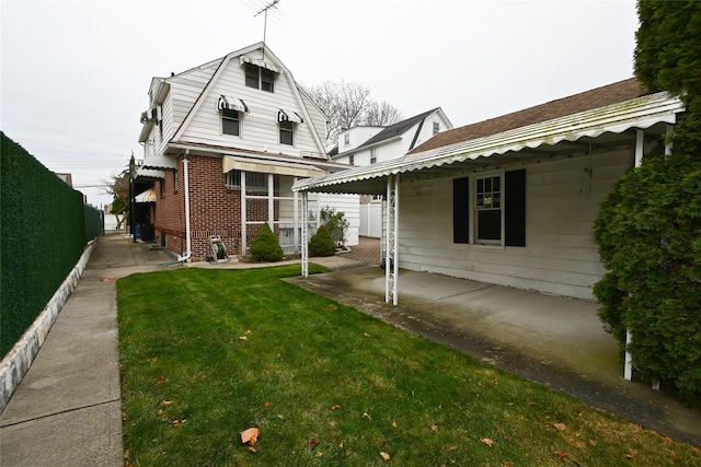 rear view of house with a patio area and a yard