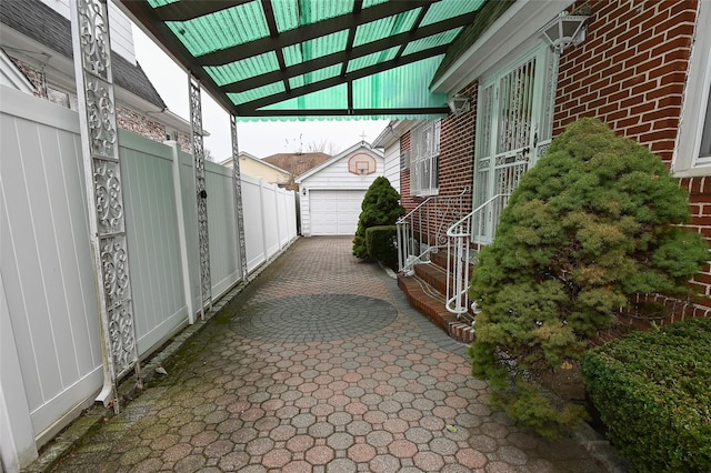 view of patio / terrace with an outdoor structure and a garage