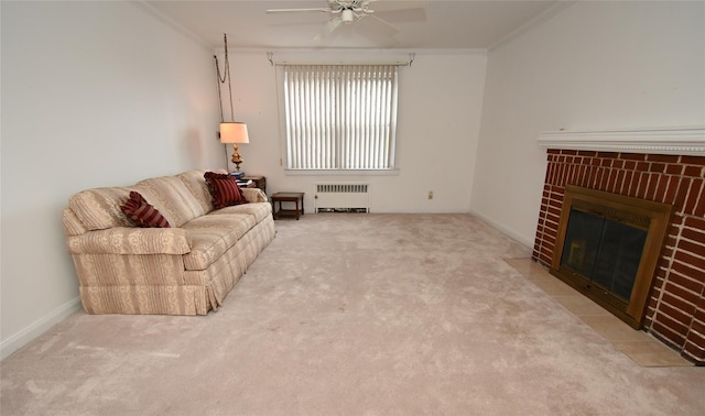 carpeted living room featuring a brick fireplace, ceiling fan, radiator heating unit, and ornamental molding