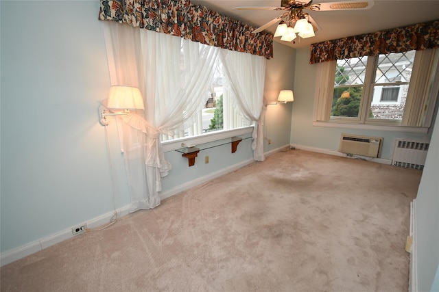 carpeted spare room featuring a wall unit AC, radiator, and ceiling fan