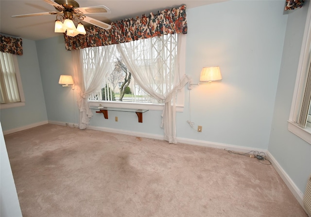 carpeted empty room featuring ceiling fan