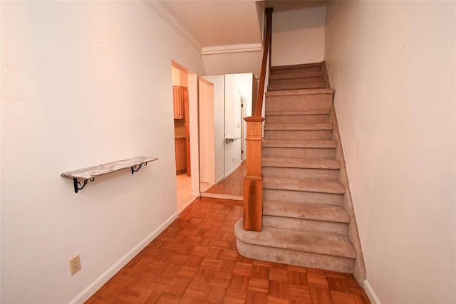 staircase featuring parquet floors and crown molding