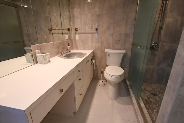 bathroom featuring tile patterned flooring, vanity, an enclosed shower, and tile walls