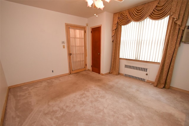 carpeted spare room featuring radiator