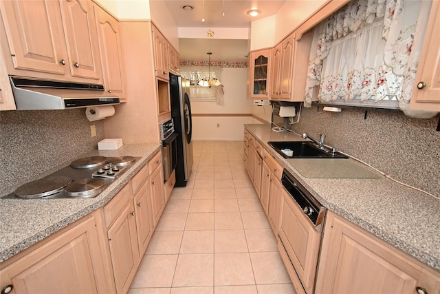 kitchen with black appliances, light brown cabinets, sink, and hanging light fixtures