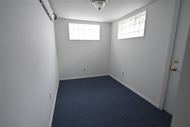 carpeted spare room featuring a barn door