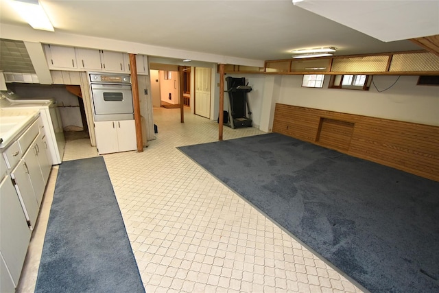 interior space with washer and clothes dryer and stainless steel oven