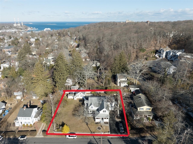 bird's eye view with a water view and a wooded view