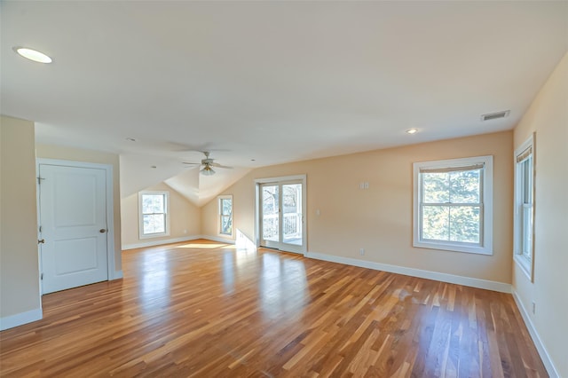 unfurnished room with light wood-style floors, visible vents, ceiling fan, and baseboards