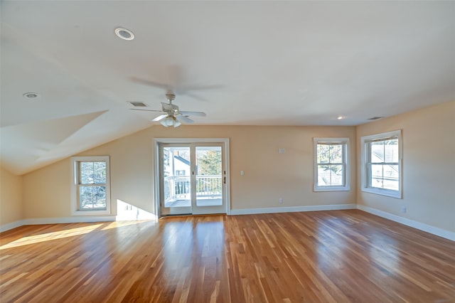 interior space with plenty of natural light, baseboards, and wood finished floors