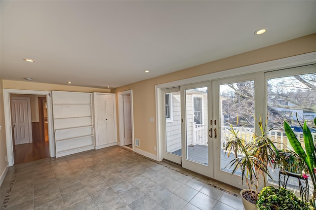 spare room featuring recessed lighting, baseboards, and french doors