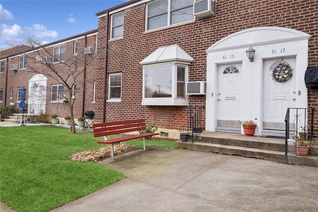 entrance to property with a lawn