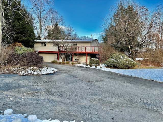 view of front of property with a wooden deck and a garage